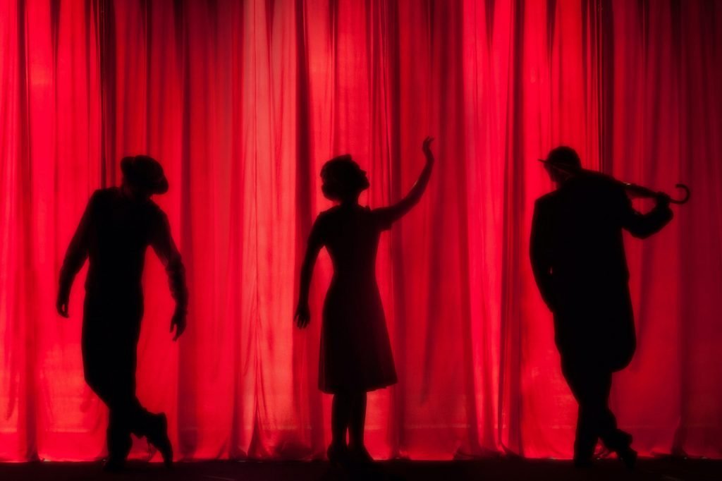 Theatre showing actors against red curtains signifying role play questions in MMI Interviews.