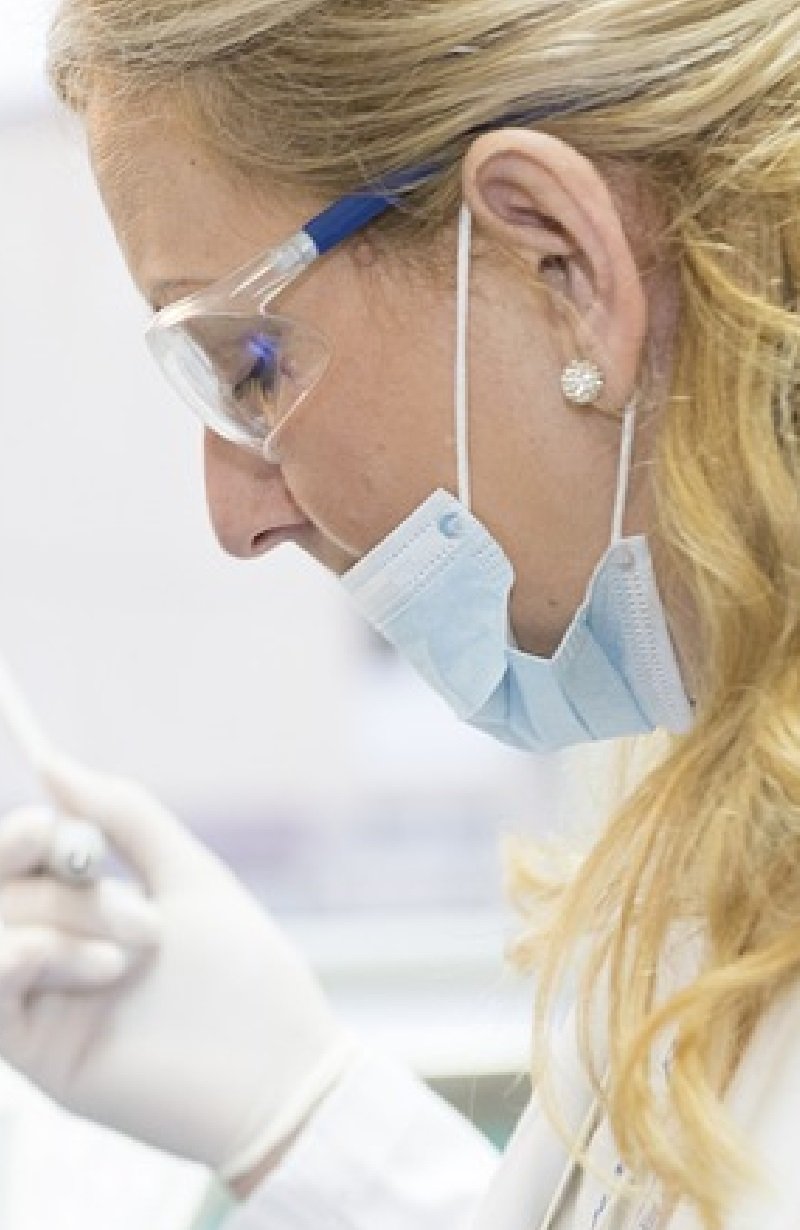 Doctor doing an examination Doctor in White Scrubs and gloves doing an examination